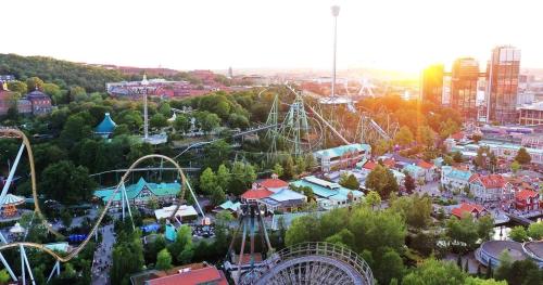 an amusement park with a ferris wheel and rides at Central studio apartment in Gothenburg