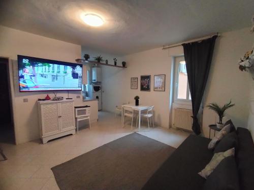 a living room with a large flat screen tv at Roma Home in Trento