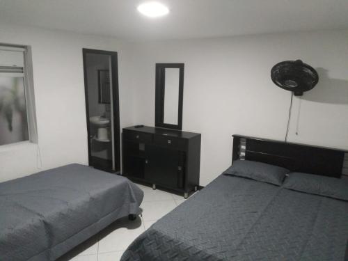 Ένα ή περισσότερα κρεβάτια σε δωμάτιο στο Hotel Murano Medellín