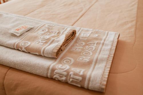 a pair of towels sitting on top of a bed at Rigo Hotel in Santa Rosa