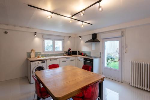 a kitchen with a table and a sink and a stove at Au 9ème Art in La Rochefoucauld