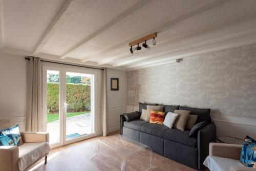 a living room with a couch and a window at Au 9ème Art in La Rochefoucauld