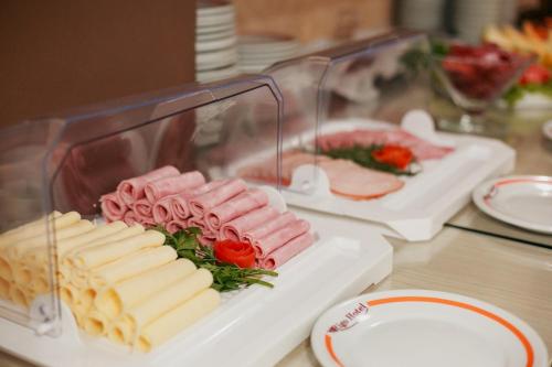 a tray of cheese and meats on a table at Rigo Hotel in Santa Rosa