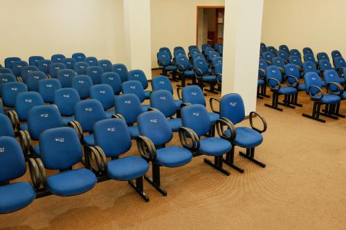 a group of blue chairs in a room at Rigo Hotel in Santa Rosa