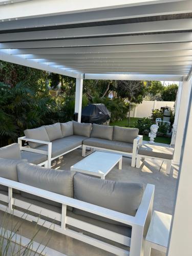 a patio with couches and a table on a patio at Men only clothing option guesthouse near Wilton Manors in Fort Lauderdale
