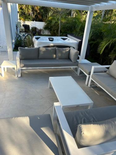 a group of couches and tables on a patio at Men only clothing option guesthouse near Wilton Manors in Fort Lauderdale