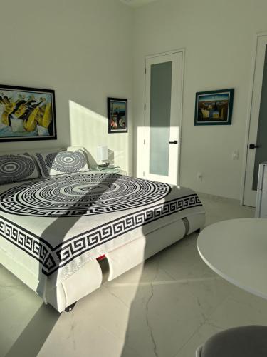 a large bed in a room with a table at Men only clothing option guesthouse near Wilton Manors in Fort Lauderdale