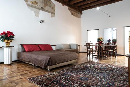a bedroom with a bed and a dining room with a table at Casa Turandot Verona in Verona