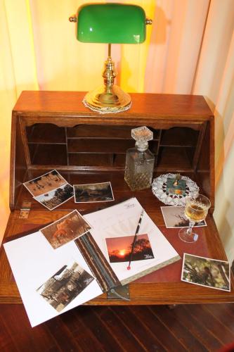 a desk with a lamp and photographs on it at Out in Africa Wildlife Lodge in Dinokeng Game Reserve