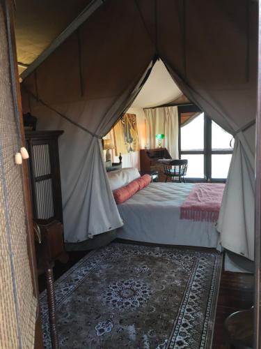 a bedroom with a bed in a tent at Out in Africa Wildlife Lodge in Dinokeng Game Reserve