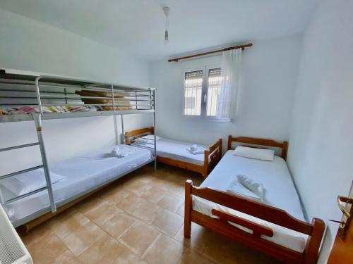 a room with two bunk beds and a window at HOUSE BTS(BY.THE.SEA) in Stavros