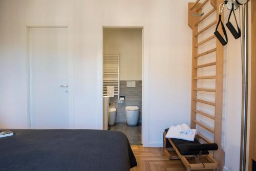 a bedroom with a staircase leading to a bathroom at Dimora San Bartolomeo - Design, Panoramic View & Culture in Rome