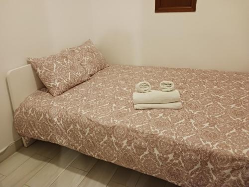 a bed with two towels on top of it at Apartment Estrela Heart in Lisbon