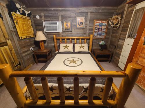 a bedroom with a bed in a wooden room at Buffalo Girls Hotel in Canton