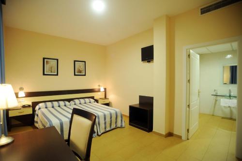 Postel nebo postele na pokoji v ubytování Hotel Castillo