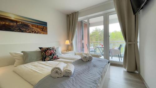 Voodi või voodid majutusasutuse Strandhaus-Nordseebrandung-Fewo-A2-3 toas