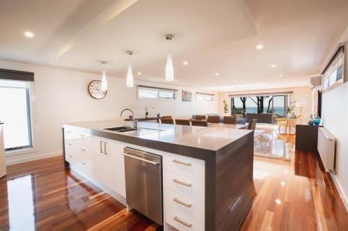 a kitchen with a sink and a counter top at Luxurious 4 Bedroom House with Stunning Beach view in St Leonards in Saint Leonards