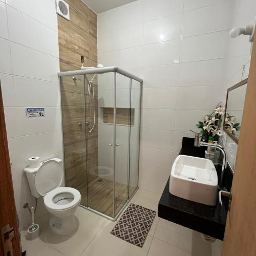 a bathroom with a shower and a toilet and a sink at Sítio Sonho da Vovó in Esmeraldas