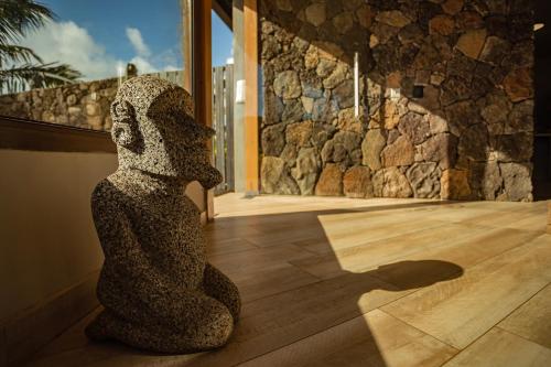 a statue of a bear sitting on a wooden floor at Hotel Ohana Rapa Nui in Hanga Roa