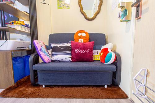 a blue chair with pillows on it in a room at Pandora's Nest in Manila