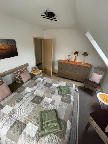 a bedroom with a large bed and a dresser at Oase der Ruhe 2 in Waldsieversdorf