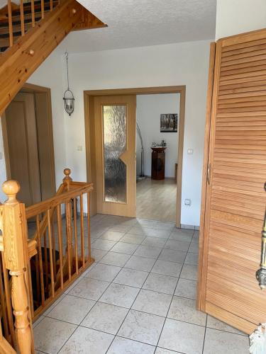 a hallway with a wooden staircase and a stair case at Oase der Ruhe 2 in Waldsieversdorf