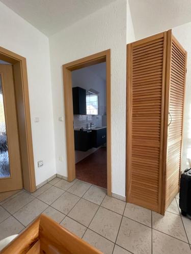 a room with two doors and a room with a kitchen at Oase der Ruhe 2 in Waldsieversdorf
