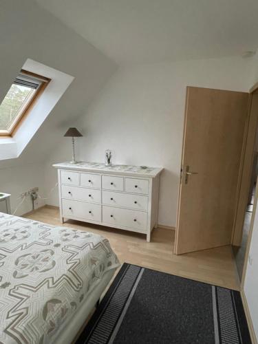 a bedroom with a bed and a dresser and a window at Oase der Ruhe 2 in Waldsieversdorf
