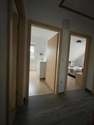 an open doorway to a bedroom with a bed at Oase der Ruhe 2 in Waldsieversdorf