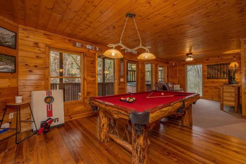 a room with a pool table in a cabin at Voted #1 Cabin in Smokys! Spa, Arcade, Private, Creek, King Beds in Sevierville