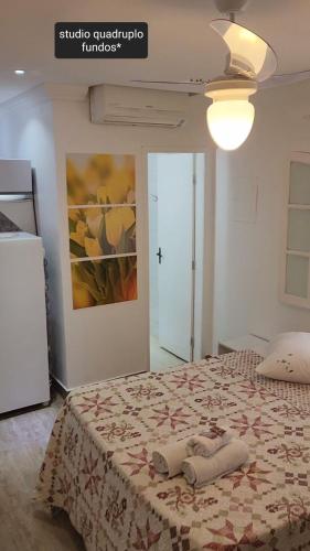 a bedroom with a bed with a quilt on it at Pousada Miragem Do Mar Cabo Frio Praia Do Peró in Cabo Frio