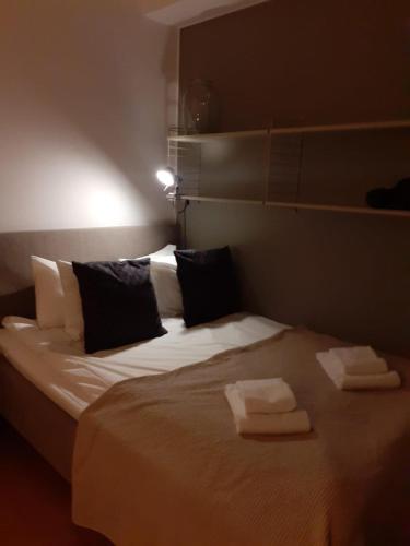 a bedroom with a large bed with two towels on it at Two room Apartment in Sundbyberg Stockholm in Sundbyberg