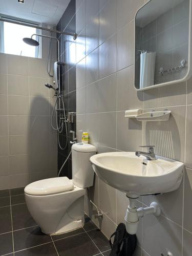 a bathroom with a toilet and a sink at CiptaRase Apartment - Drawbridge,KTCC mall, Kuala Terengganu in Kuala Terengganu