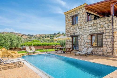 a villa with a swimming pool and a house at Villa Aphrodite in Argaka