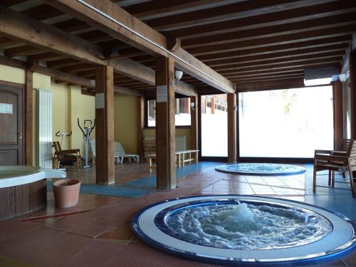 a room with a large tub in the middle of a house at Hotel Cà Fiore in Bardonecchia