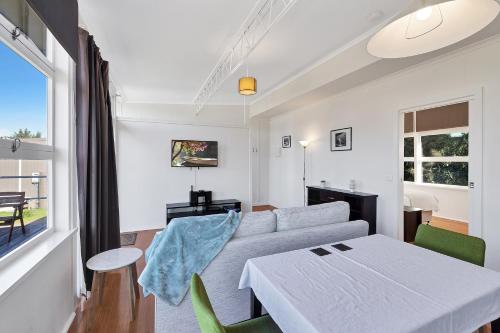 a living room with a couch and a table at Harmony at Tower Hill in Koroit