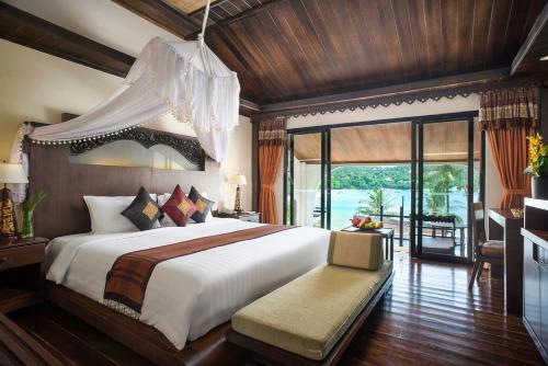 a bedroom with a large bed and a large window at Panviman Resort Koh Phangan - SHA Extra Plus in Thong Nai Pan Noi
