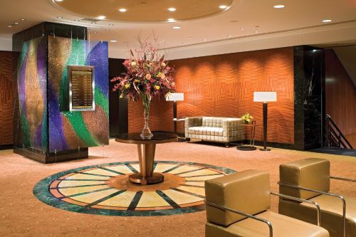 a lobby with a vase of flowers on a table at Millennium Hotel Broadway Times Square in New York
