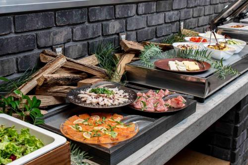 a buffet with plates of food on a table at Hotel It Osaka Shinmachi in Osaka