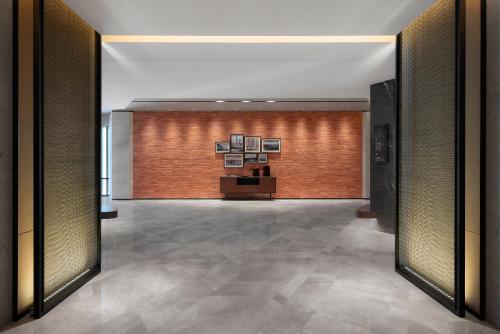 a hallway with a brick wall and a lobby at Four Points by Sheraton Shenzhen Bao'an in Shenzhen
