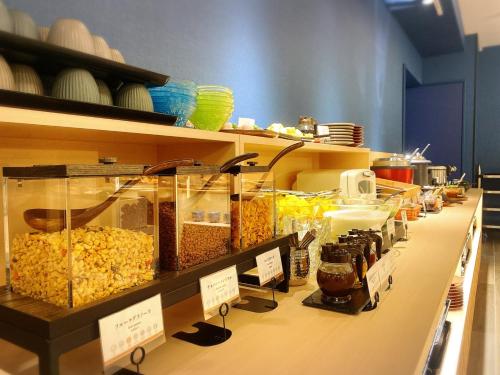 a long counter with many different types of food at La'gent Hotel Kyoto Nijo in Kyoto