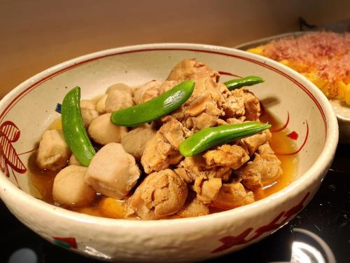 a bowl of food with chicken and green peppers at La'gent Hotel Kyoto Nijo in Kyoto