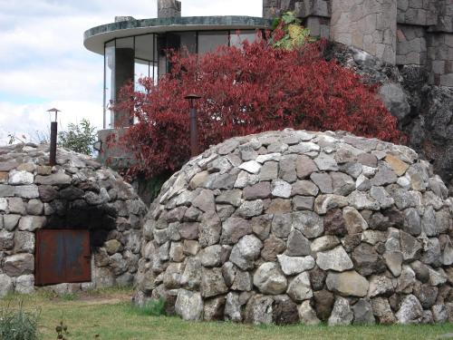 a stone wall with a door in front of a building at Hotel Tiosh Abaj in Santiago Atitlán