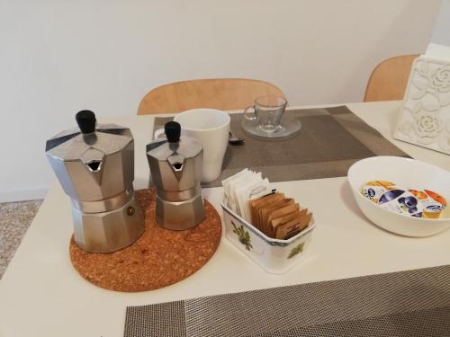 a table with a coffee maker and a plate of food at il 64B - 10 minuti a piedi dal Policlinico San Matteo - in Pavia