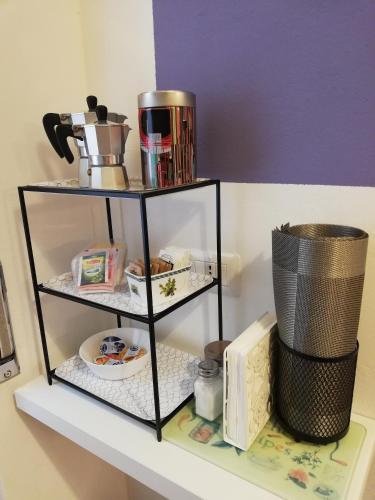 a shelf with food and a coffee pot on it at il 64B - 10 minuti a piedi dal Policlinico San Matteo - in Pavia
