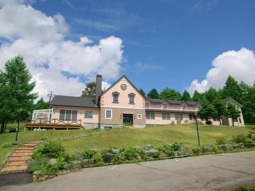 ein großes Haus auf einem Hügel in der Unterkunft Petit Hotel Kanan in Chino