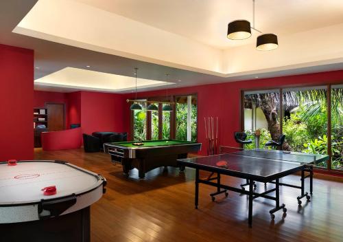 a living room with a pool table and ping pong ball at Niyama Private Islands Maldives in Dhaalu Atoll