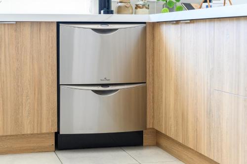 a kitchen with a stainless steel dishwasher under a counter at Ocean & Country Views, Spa, Pets Welcome, Fireplace - Your Ocean Oasis 10 minutes to Phillip Island in Kilcunda