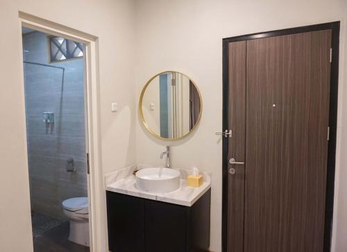 a bathroom with a sink and a mirror and a toilet at INAGRO in Bogor