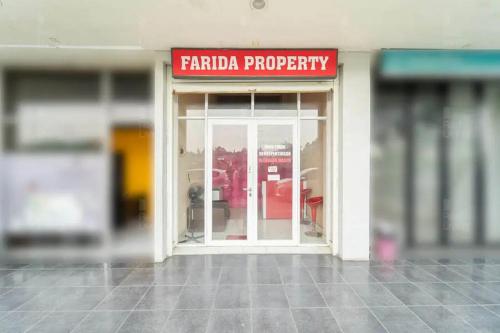 a store front with a red sign on the door at RedLiving Apartemen Serpong Green View - Farida Property in Ciater-hilir